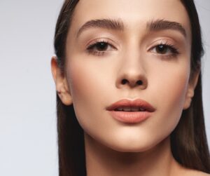 Closeupportraitofattractivewomanwithshoulderslookingat | Cornerstone Plastic Surgery 